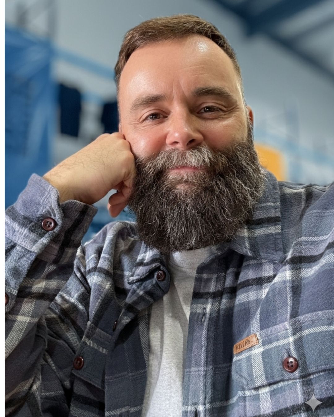 JW, founder of Cedar Cipher, resting his chin on his hand and looking directly at the camera with a warm, approachable smile